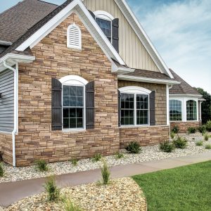 Stone siding added to an curb facing architectural section of a home, in plumcreek colour.