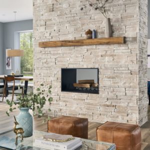 image of stone siding used indoors to create an authentic looking stone fireplace in the center of the homes entertainment area, in sand colour.