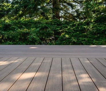 Photo of a Back Deck Project, made from composite deck boards in Chatham-Kent Ontario with Wooded Area in the Background