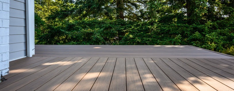Photo of a Back Deck Project, made from composite deck boards in Chatham-Kent Ontario with Wooded Area in the Background