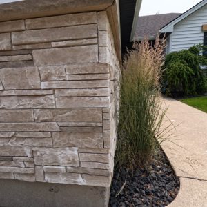 image of stone siding added to the bottom part of the home as a textural accent in a mission point colour.