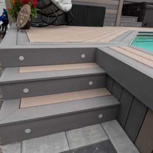 Close up image of deck stairs with built in gemstone deck lighting