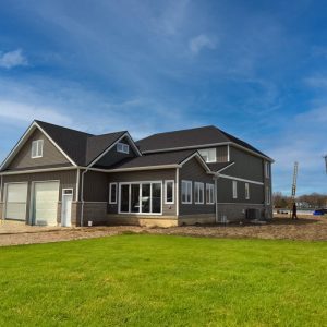 Back Of Home View of A Newly Construction home finished with a mix of Vertical and horizontal vinyl siding in Castlemore colour